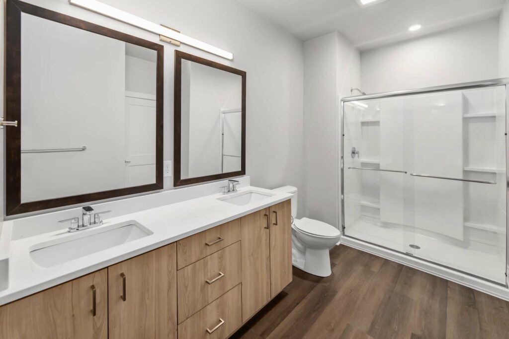 Full bathroom with double sinks and walk-in shower